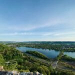 green trees and body of water under blue sky during daytime